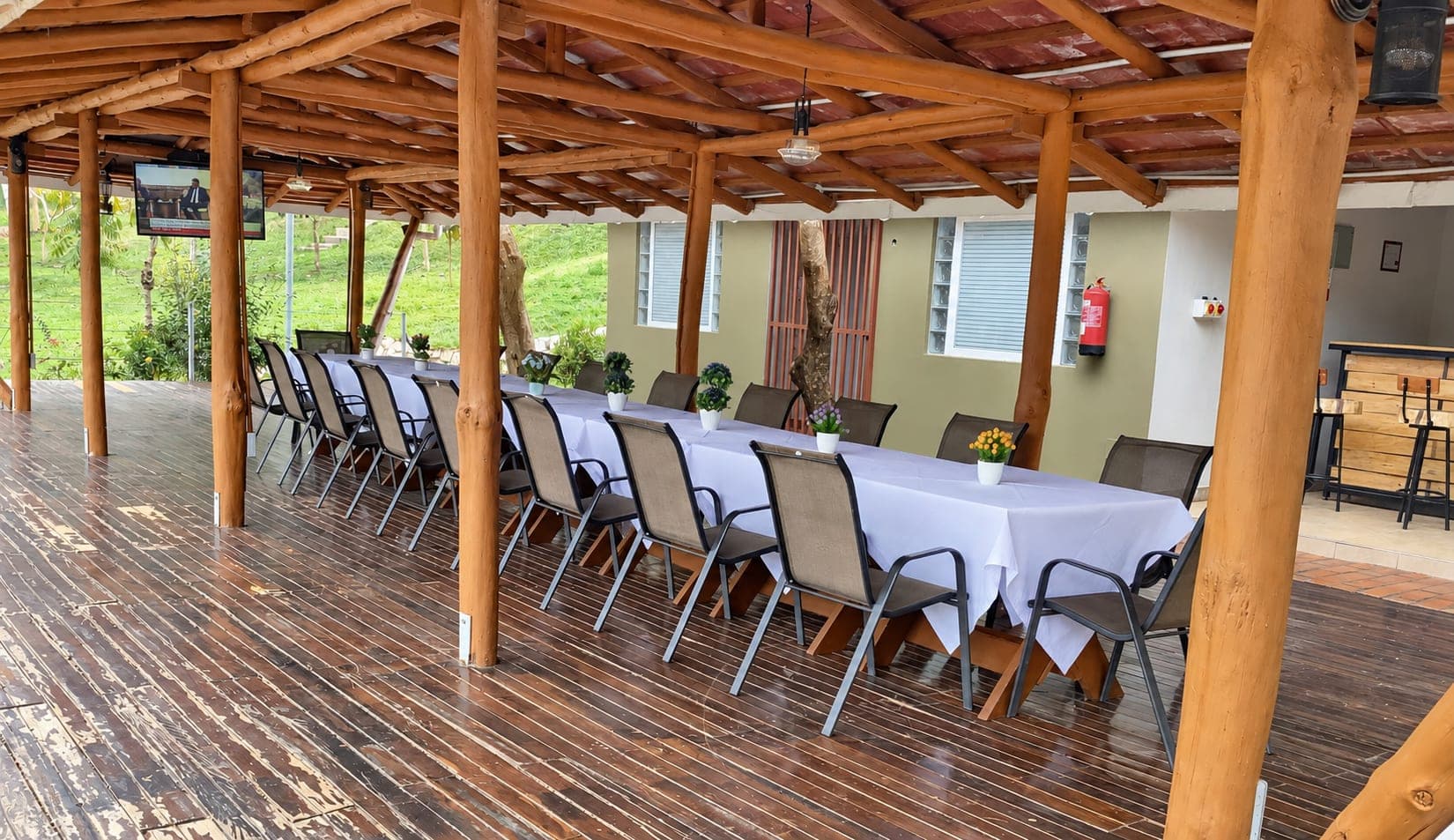 The covered timber deck set with long banquet tables