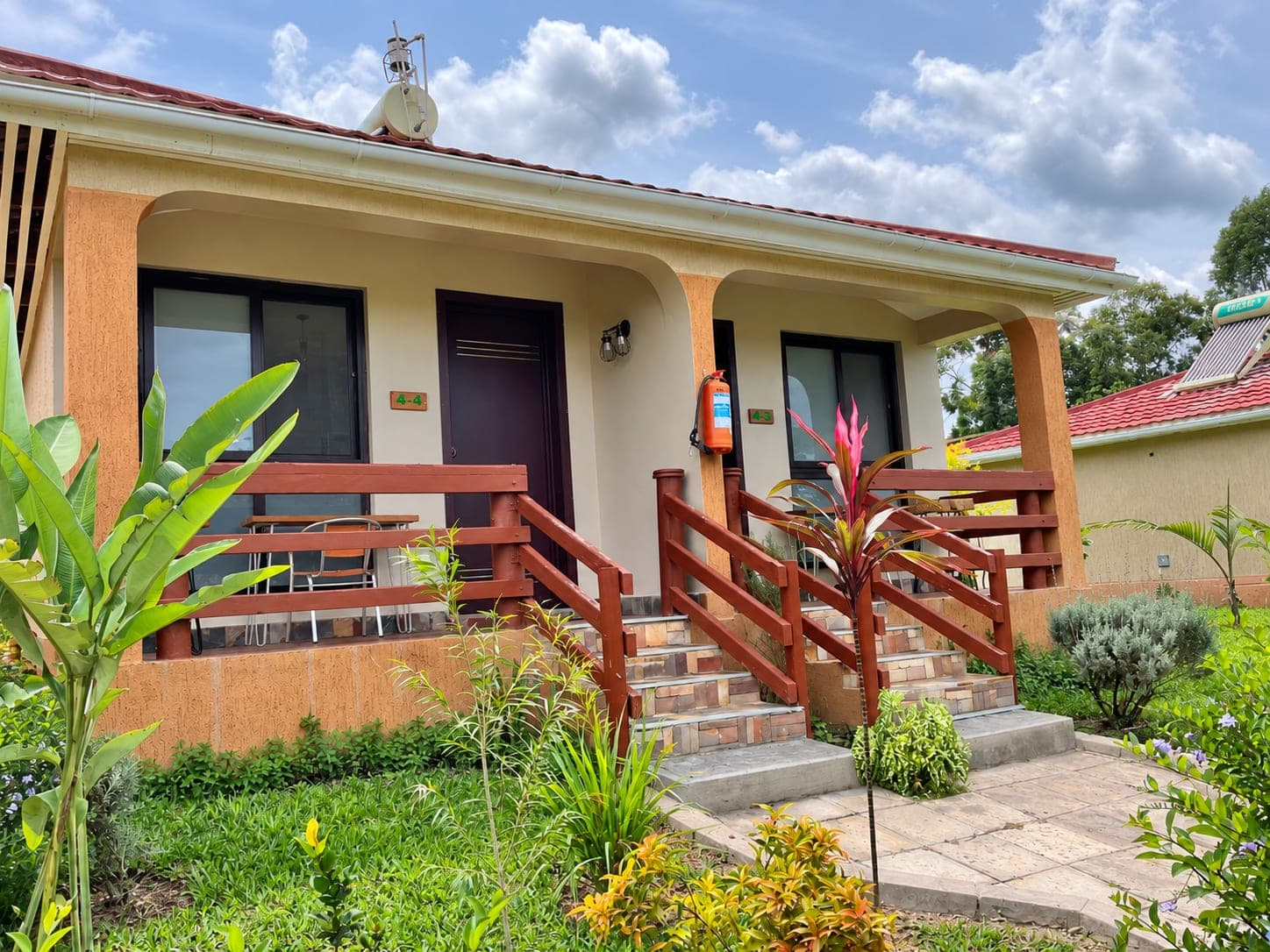 The lodge exterior with two shaded verandas and garden planting