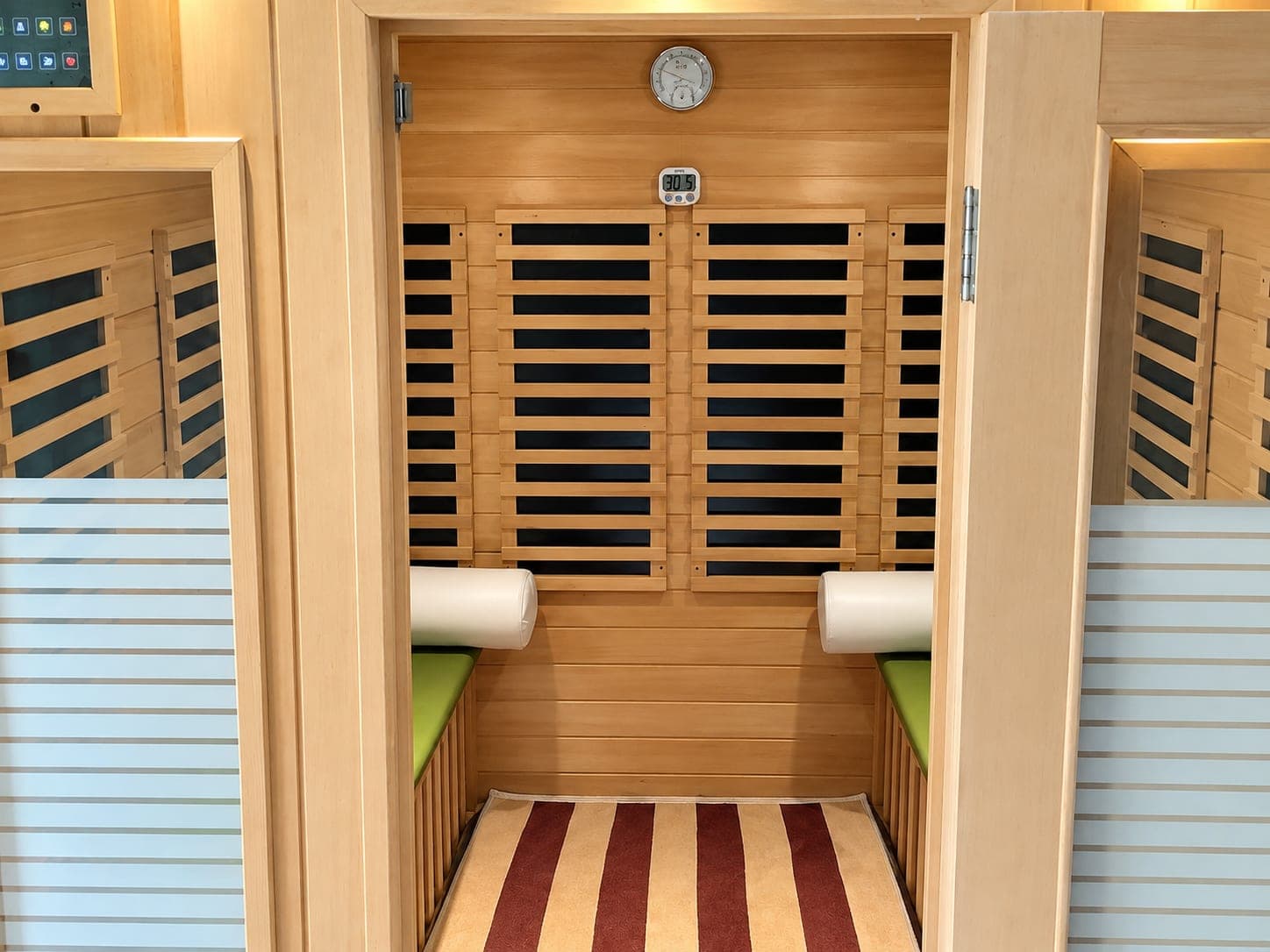 The timber sauna with bench cushions and a heater